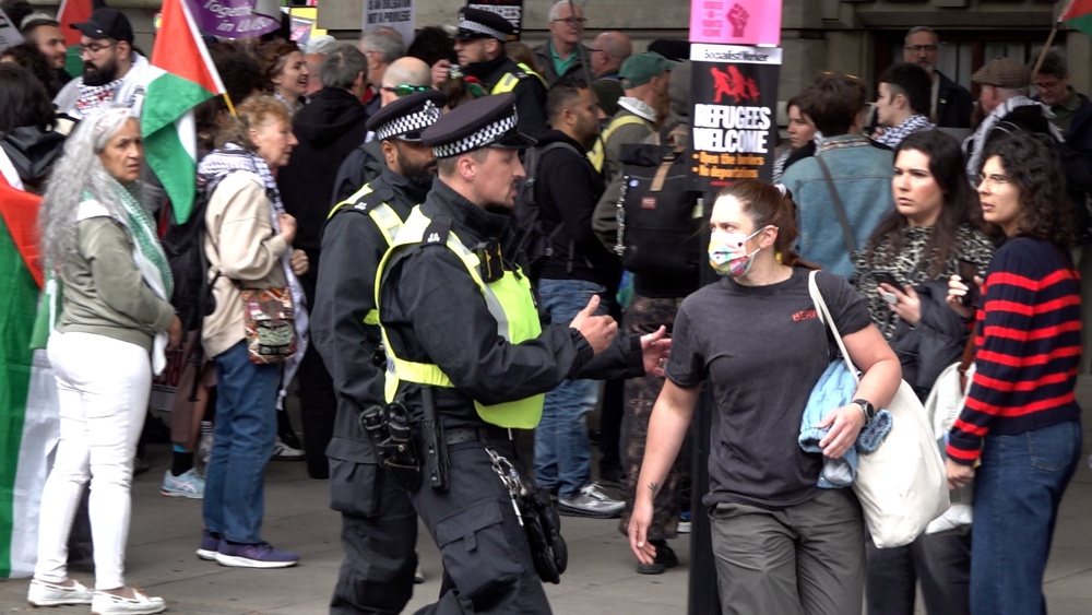 Police engage with a person during the pro-Palestine march in central London (Zhanna Manukyan/PA) (PA Wire)