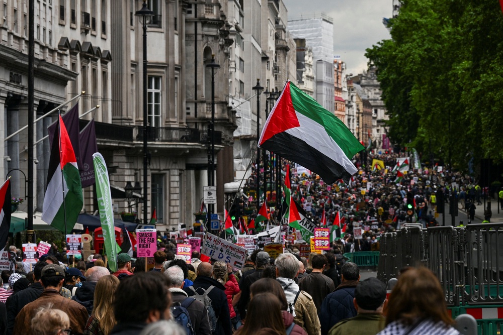 People carry signs and Palestinian flags as demonstrators from the Palestine Solidarity Campaign hold a march to mark the 78th anniversary of the Nakba (REUTERS)