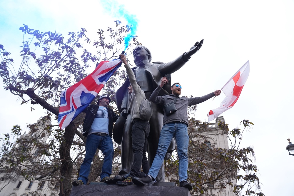 People take part in Tommy Robinson's Unite the Kingdom march in central London (PA)