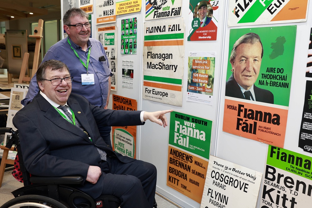 Former Taoiseach Brian Cowen (left) looks at an exhibition of election literature (Conor O Mearain/PA) (PA Wire)