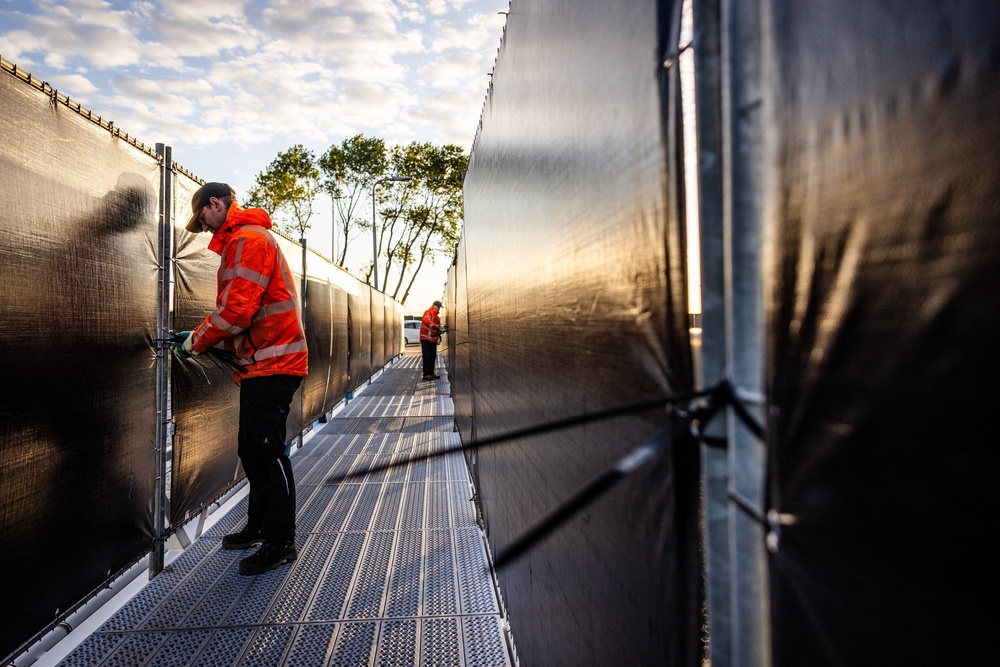 Employees prepare for the arrival of the Dutch Hantavirus-hit cruise ship MV Hondius at the port of Rotterdam on 16 May 2026 (AFP/Getty)