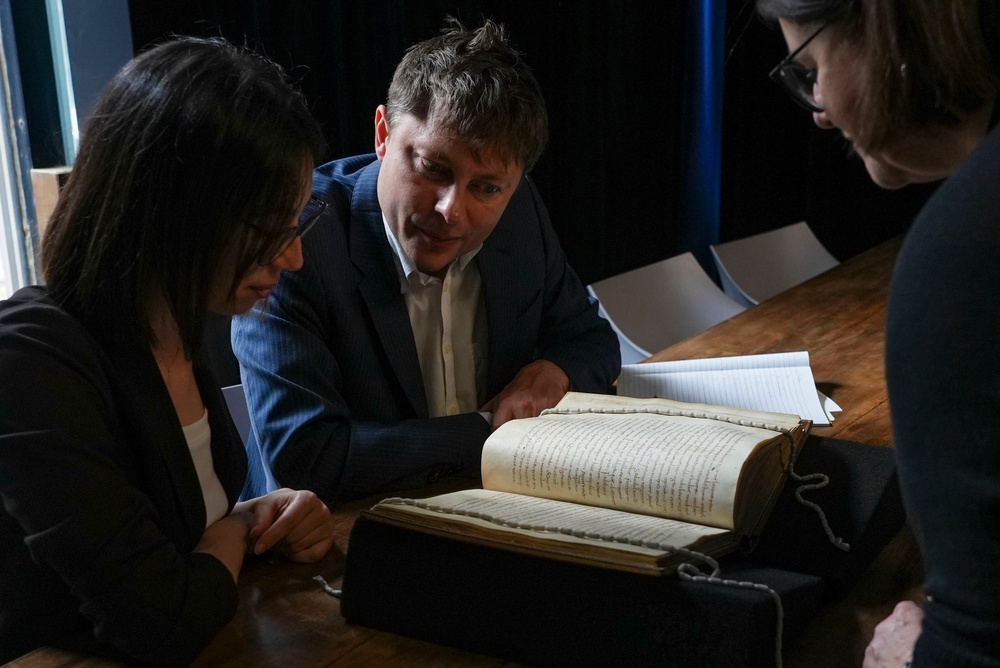 From left, Elisabetta Magnanti and Mark Faulkner from Dublin's Trinity College and Valentina Longo of Rome's National Central Library look at a manuscript containing a rare, long-lost copy of Caedmon's Hymn (AP)
