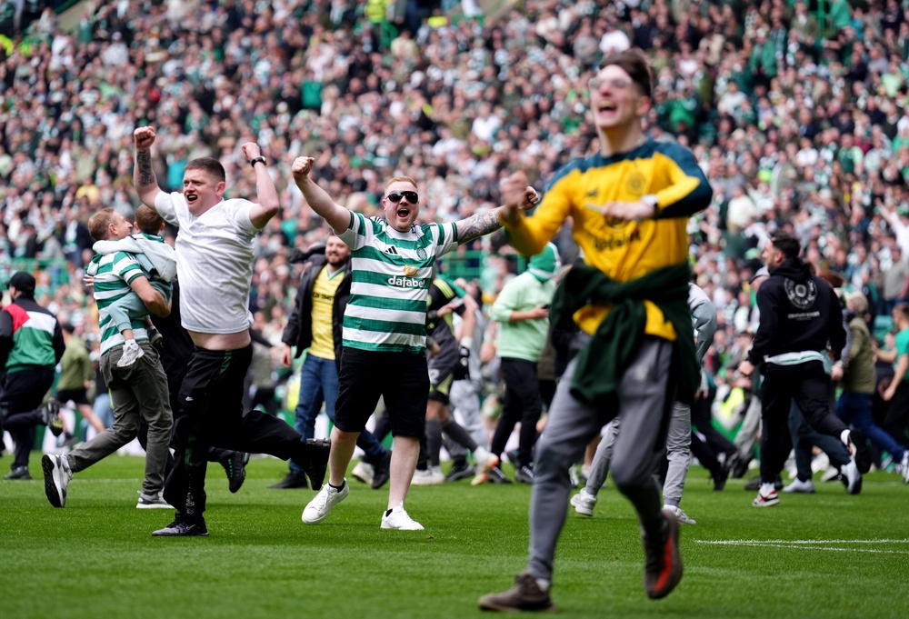 Celtic fans invaded the pitch after the third goal (PA)