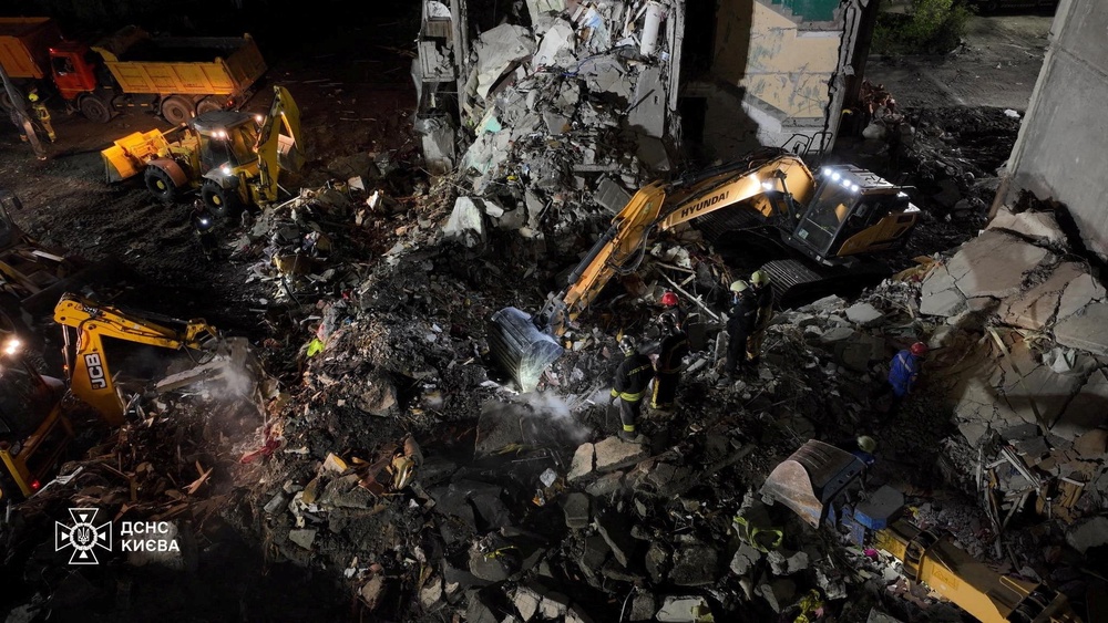 Firefighters work at the site of an apartment building damaged during Russian missile and drone strike (via REUTERS)