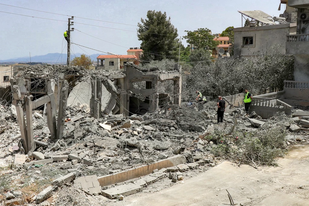 First responders inspect damage following Israeli bombardment on the village of Deir Qanoun al-Nahr in southern Lebanon (AFP/Getty)
