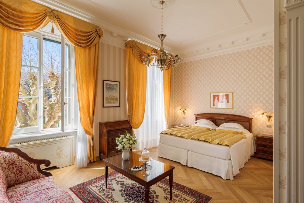 Decor combines gold detailing, silk bedspreads and ornate furniture (Grand Hotel Villa Serbelloni)