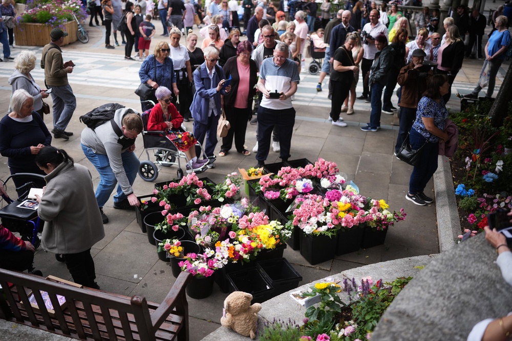 People bring tributes and flowers to lay outside The Atkinson on the first anniversary of the Southport stabbings. Elsie Dot Stancombe, 7, Bebe King, 6, and Alice da Silva Aguiar, 9, died in the horror attack in July 2025 (Getty)