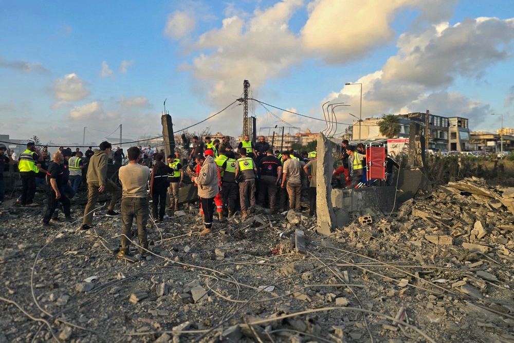 First responders gather at the site of an Israeli airstrike that targeted an area in the suburbs of the southern Lebanon coastal city of Tyre on May 16 (AFP via Getty Images)