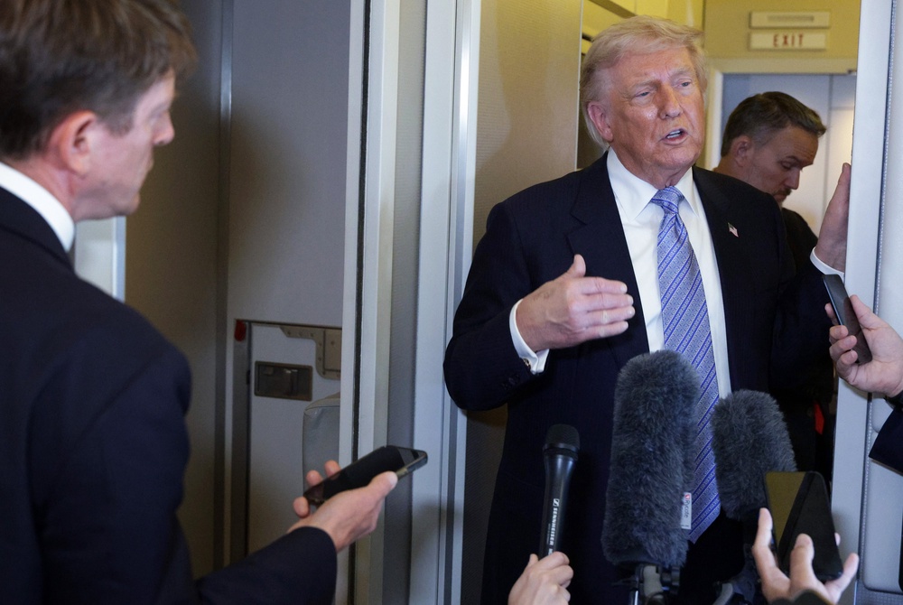 Trump speaks to the media aboard Air Force One (Getty Images)