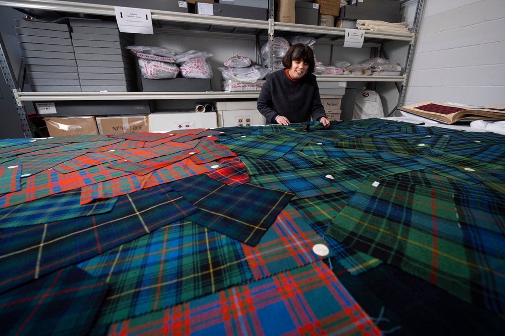 Curator Mhairi Maxwell examines the Paton tartan sample (Duncan McGlynn/PA)