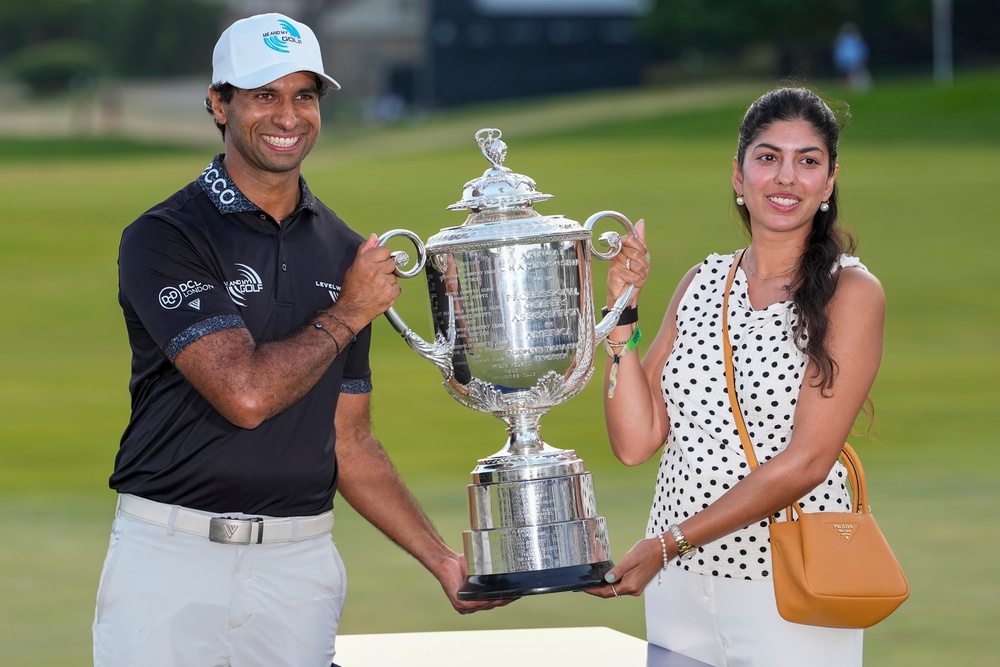 Aaron Rai holds the trophy with wife Gaurika Bishnoi (AP Photo/Frank Franklin II) (AP)