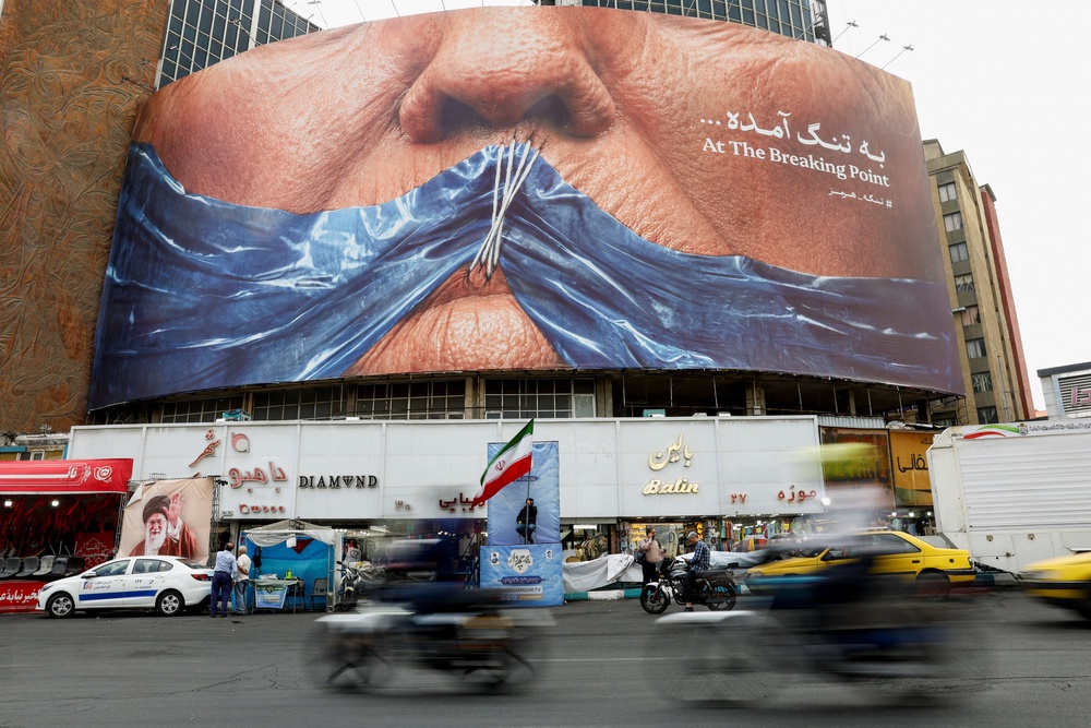 An anti-U.S. billboard depicting President Donald Trump and the Strait of Hormuz in Tehran (Reuters)