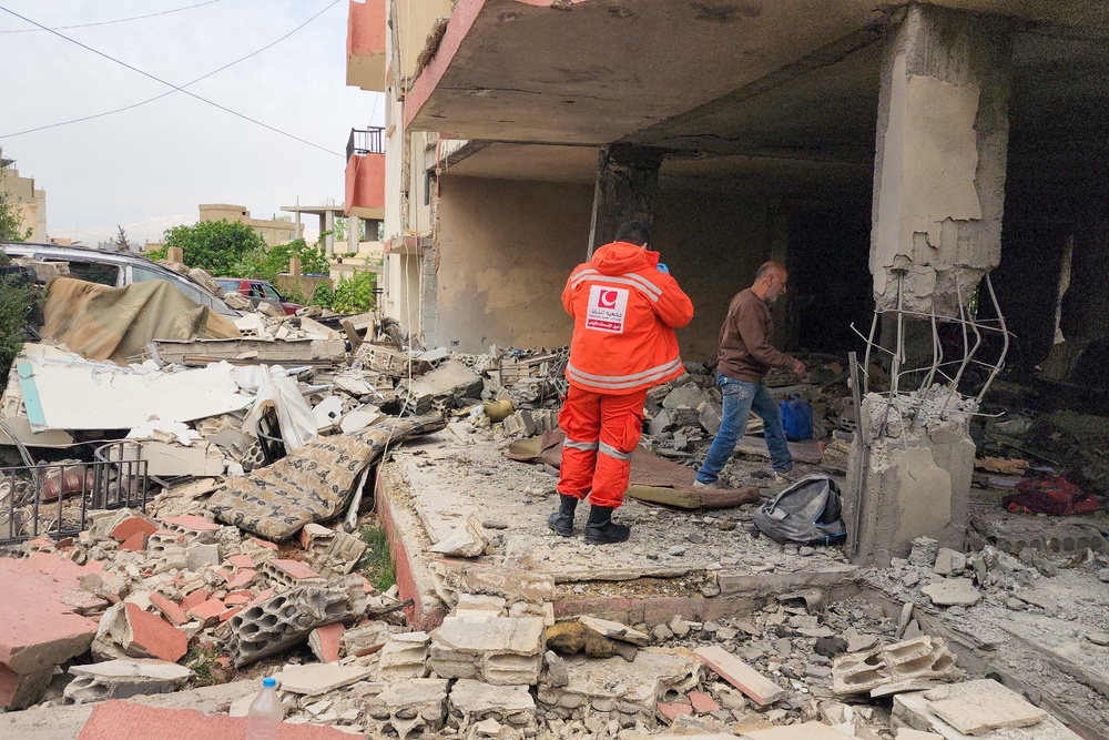 An emergency worker inspects the damage following an Israeli strike on an apartment building in Baalbek on May 18 (AFP/Getty)