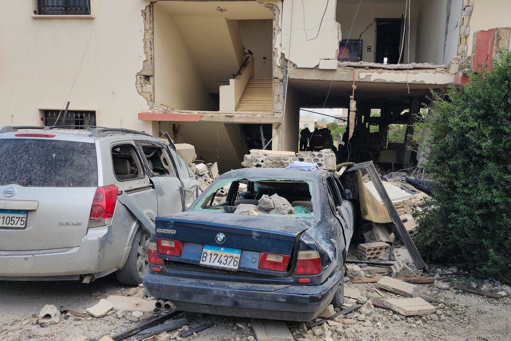 Emergency workers inspect the damage following an Israeli strike on an apartment building in Baalbek on May 18 (AFP/Getty)