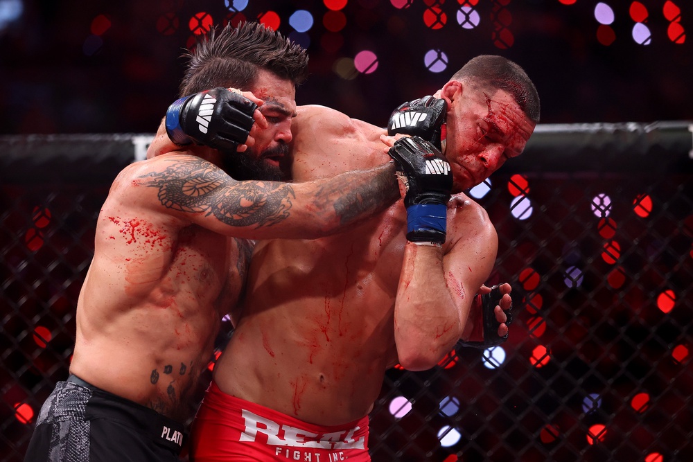 Nate Diaz (right) was badly bloodied by Mike Perry en route to a stoppage loss (Getty)