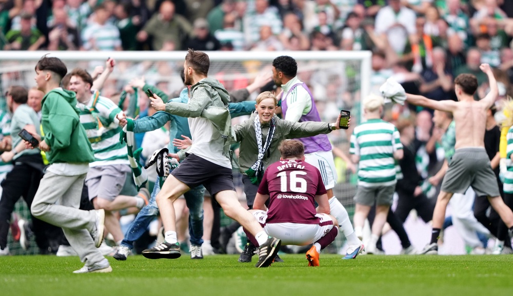 Fans invaded the pitch at Celtic Park after the home side’s third goal (Andrew Milligan/PA) (PA Wire)