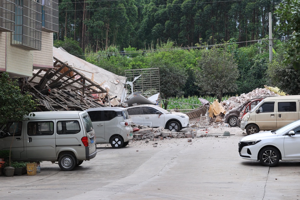 A damaged building and cars (C) are seen after an earthquake at Liunan district in Liuzhou, China's southern Guangxi region (AFP/Getty)