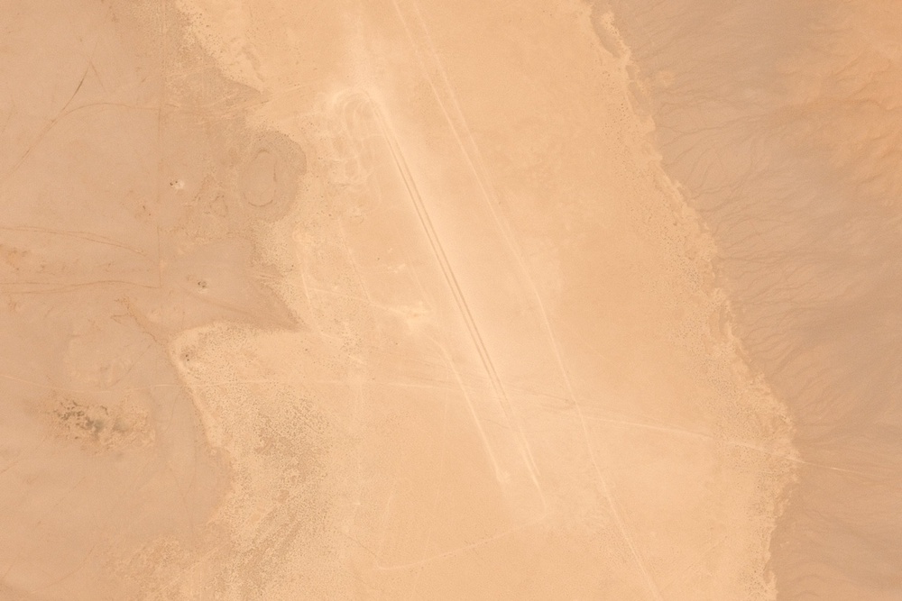 Satellite images from Airbus DS taken March 8 and analyzed by the AP appear to show a human-made track dug out at the site, some 250 kilometers (155 miles) southwest of the capital, Baghdad. The track runs in a straight line in a dried-out lake bed from northwest to southeast and measures about 1.5 kilometers (1 mile). That’s long enough for takeoffs and landing for warplanes. (AP)