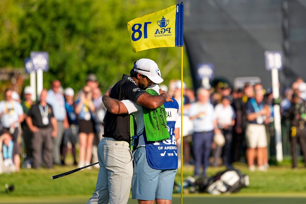 The Englishman hugs his caddie after his round (AP)