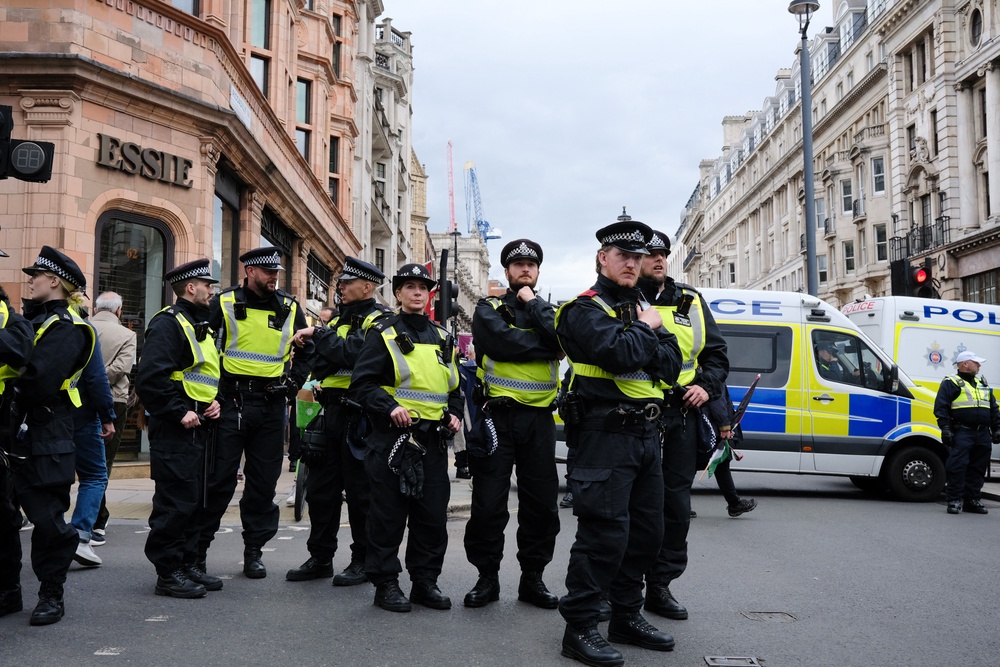 Police officers in intervention gear block a road to control the flow of the pro-Palestine march in London (AFP/Getty)