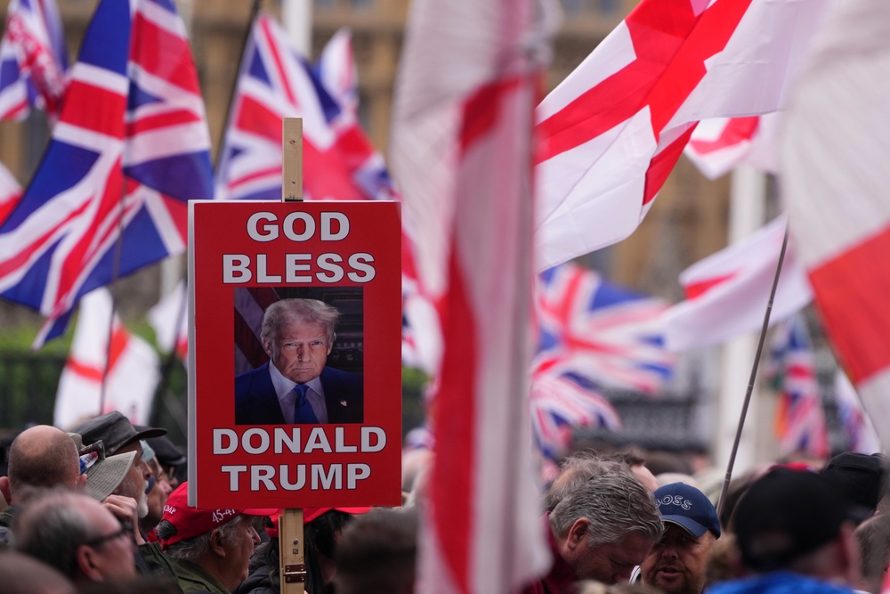 A protester holds a placard during the Unite the Kingdom march in London (AP)