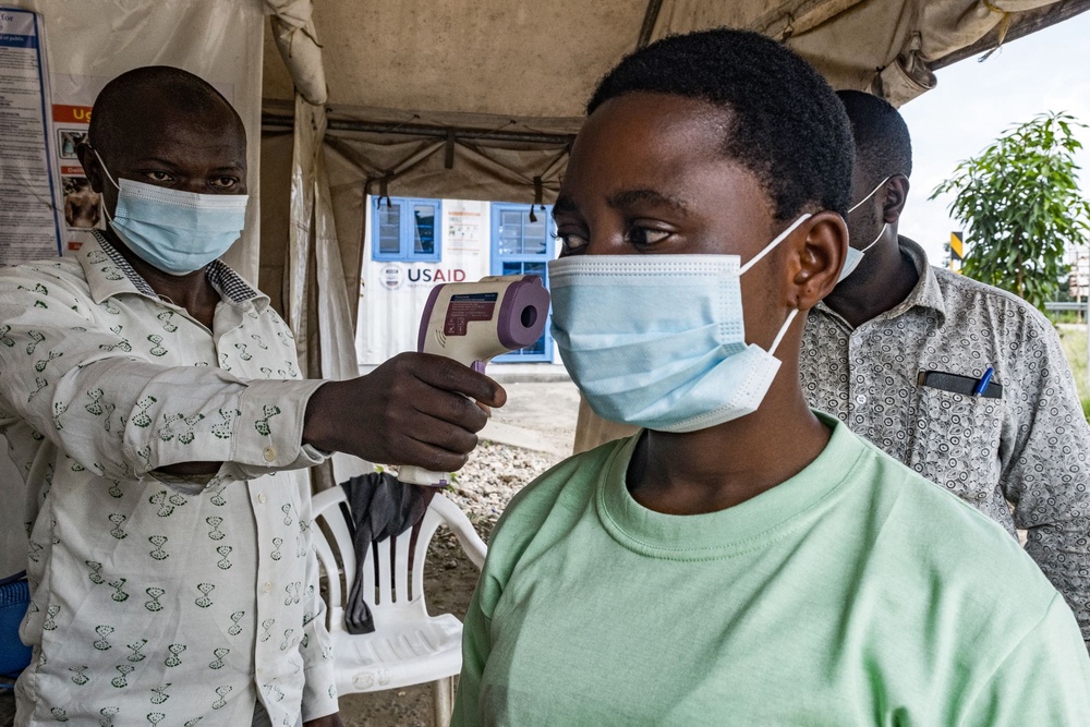 A border health officer at the Busunga crossing between Uganda and the Democratic Republic of Congo checks a traveller’s temperature as part of the ongoing response to the latest Ebola outbreak in East Africa (AFP/Getty)