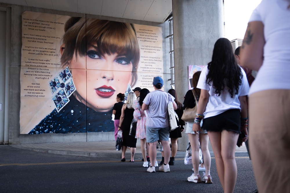 Swifties line up to pose in front of a mural outside Wembley during the Taylor Swift Eras Tour concerts at the venue in 2024 (James Manning/PA) (PA Archive)