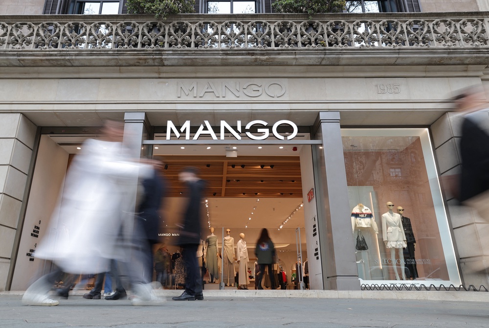 Pedestrians walk by the entrance of a Mango shop on Passeig de Gracia street in Barcelona on February 28, 2024 (AFP/Getty)