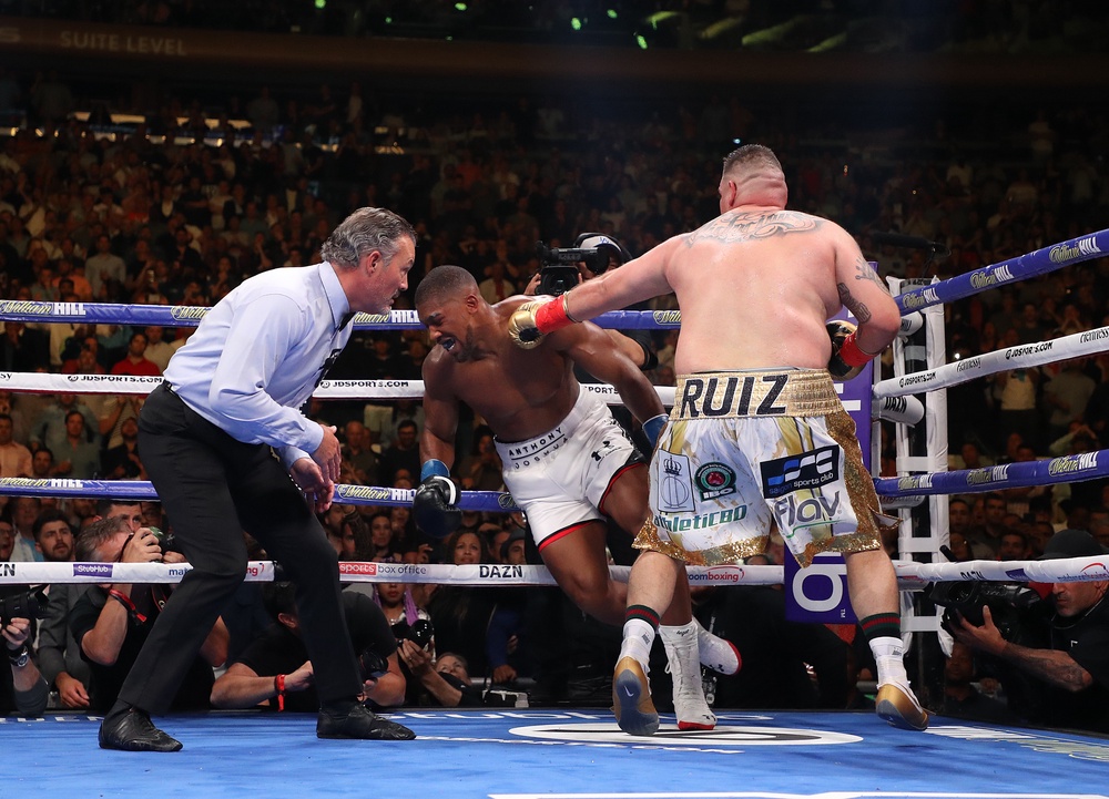 Anthony Joshua (centre) was stunned by Andy Ruiz Jr in 2019 before avenging the defeat (Getty)