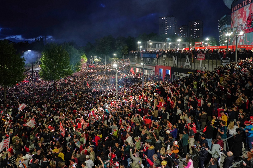 Arsenal supporters gather at the Emirates Stadium to celebrate winning the title (AP)