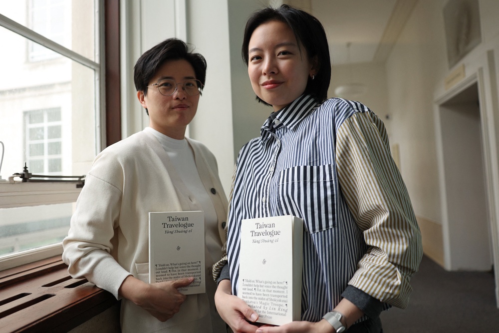 Taiwanese writer Yang Shuang-zi (left) poses with her book 'Taiwan Travelogue' beside her translator Lin King (AFP/Getty)