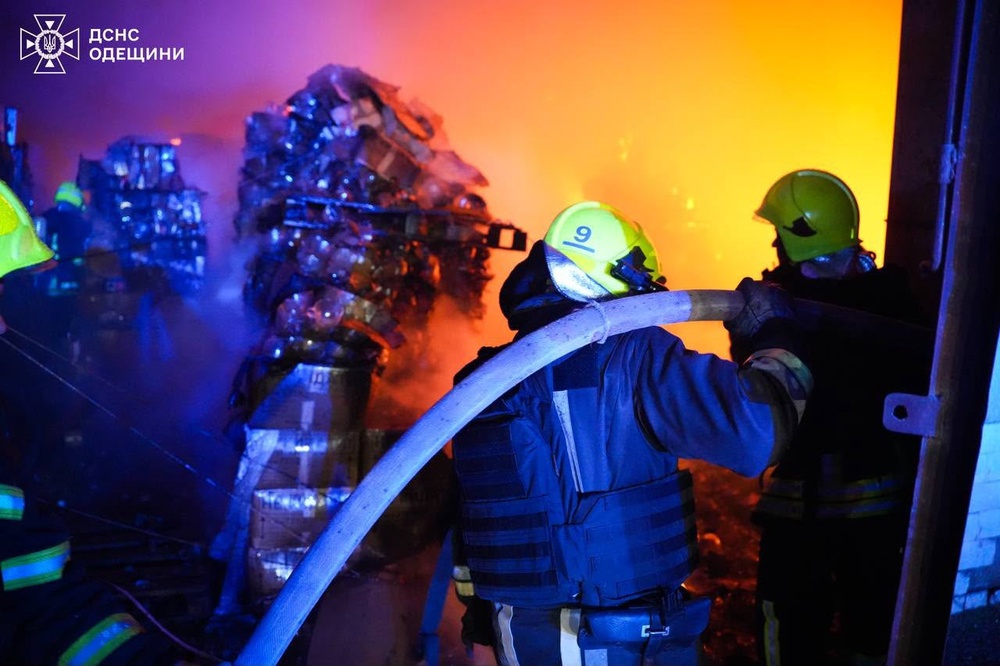 Rescue workers put out a fire inside a storage facility after a Russian strike on Odesa region on May 20 (AP)