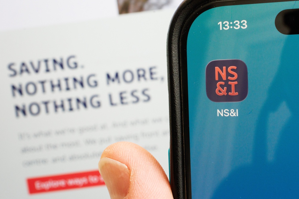 The logo of the National Savings and Investments bank is displayed on a mobile phone (Getty)