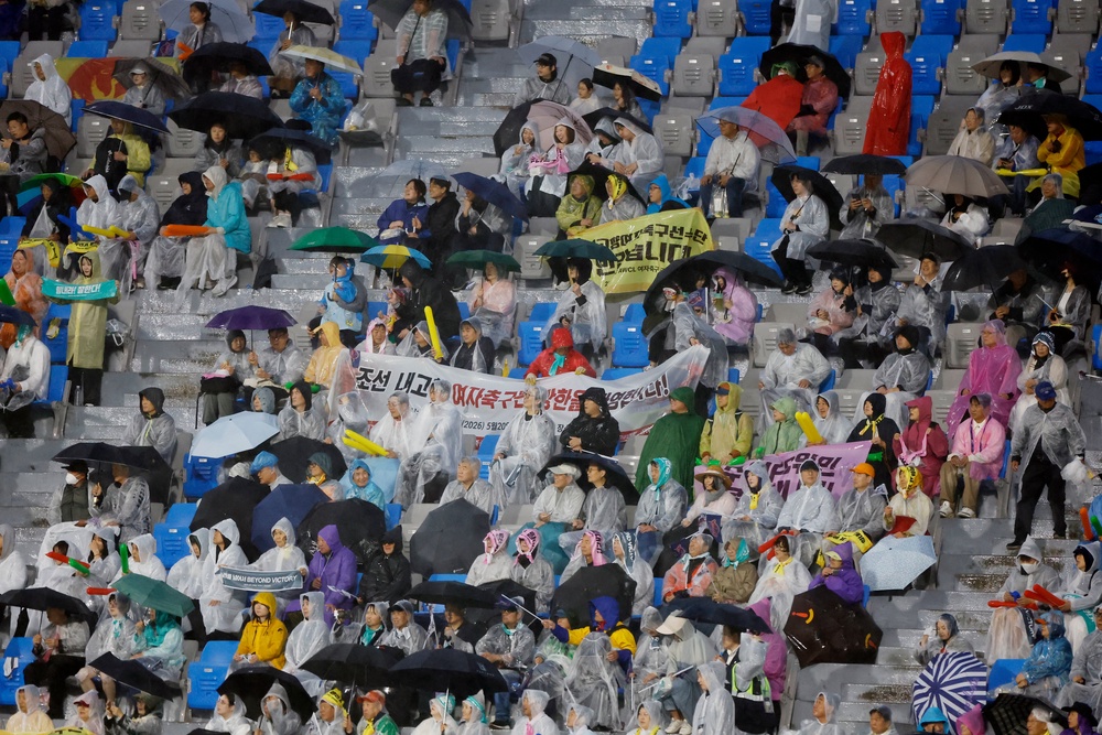 Fans braved the rain to watch the historic match (REUTERS)