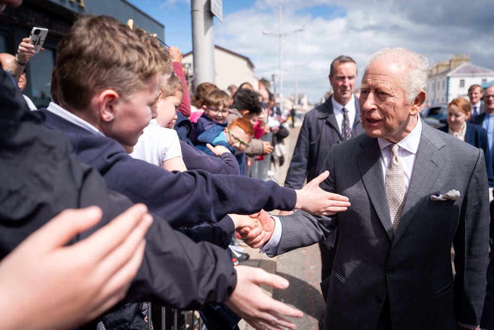 Charles joked about his encounter with the bird that left its mark on the bottom of his suit jacket as he toured the Northern Ireland town of Newcastle (PA)