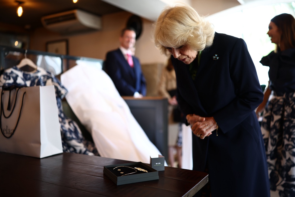 Camilla views locally produced jewellery in The Parson’s Nose pub (Henry Nicholls/PA) (PA Wire)