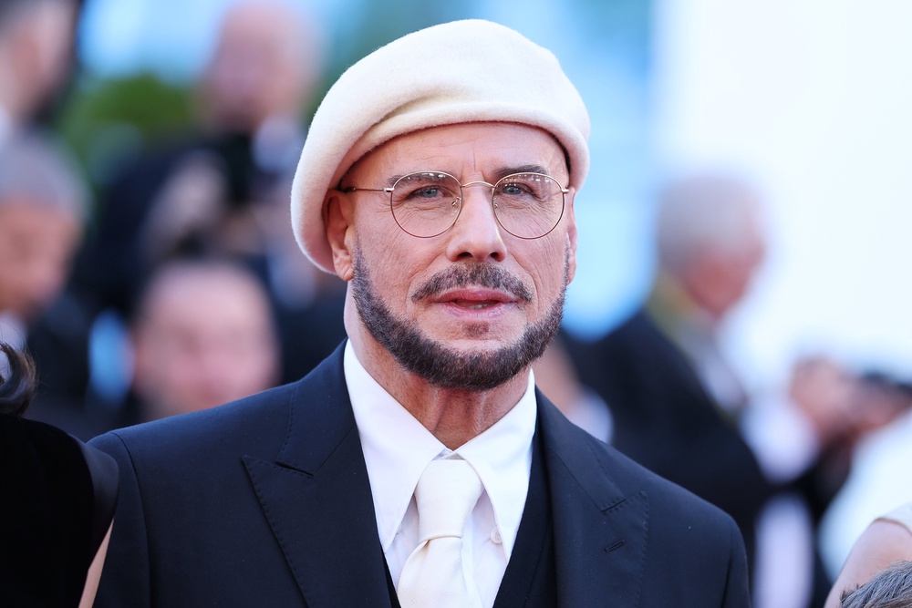 John Travolta unveiled his dramatic new look at Cannes Film Festival this week, where he is showcasing his directorial debut, ‘Propeller One-Way Night Coach’ (Getty Images)