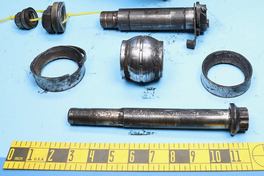 This photo released by the National Transportation Safety Board (NTSB) on Nov. 20, 2025, shows the spherical bearing and other pieces of the damaged mount of the engine (National Transportation Safety Board)