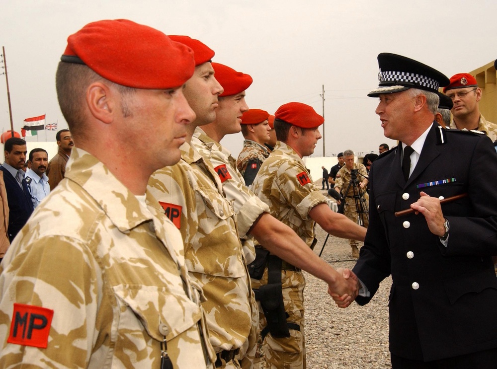 Deputy chief constable Stephen White (right) meeting some of the Royal military police during the official opening of the Regional Police Training Academy at Az Zubayr, Iraq in 2003 (PA) (PA Media)