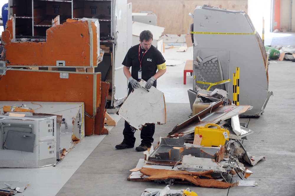 An investigator from the BEA (the French bureau leading the crash investigation) inspects debris from the mid-Atlantic crash of Air France flight 447, in July 2009 (AFP/Getty)