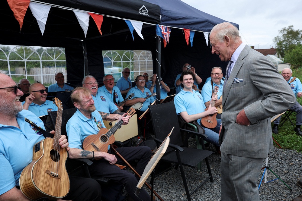 The King chatted to members of the Loughries Men’s Shed Ukulele Ensemble during his visit (Toby Melville/PA) (PA Wire)