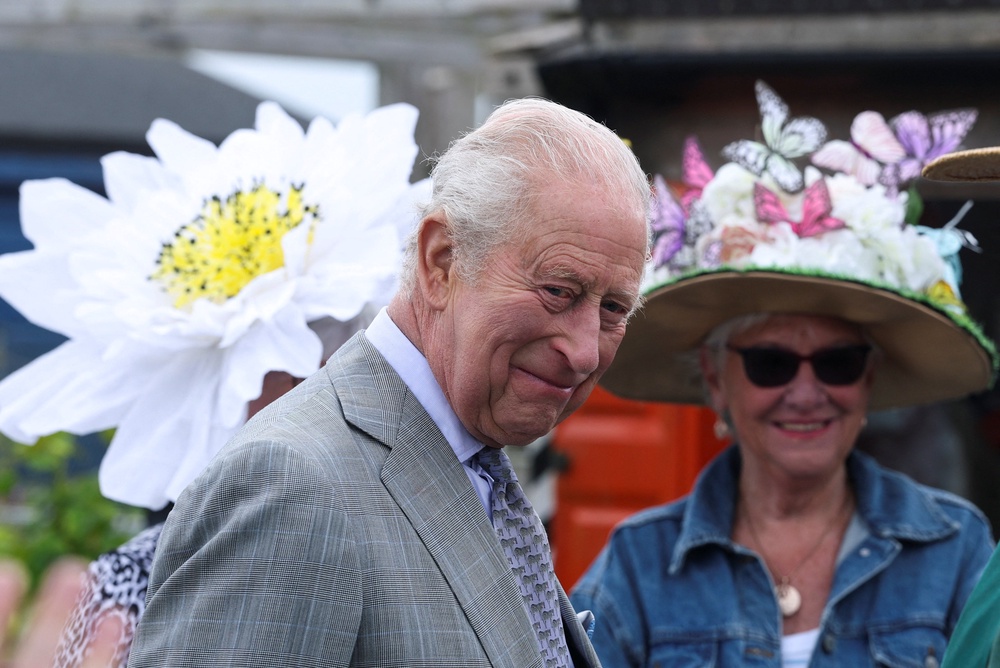 Some allotment users wore floral design hats to meet the King (Toby Melville/PA) (PA Wire)