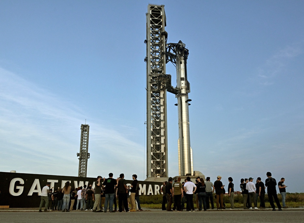 A crowd gathers near launch pad 2 to look at the SpaceX Starship spacecraft and the Super Heavy Booster as preparations continue for the 12th test flight of the Starship spacecraft in Starbase, Texas, on 20 May, 2026 (Reuters)