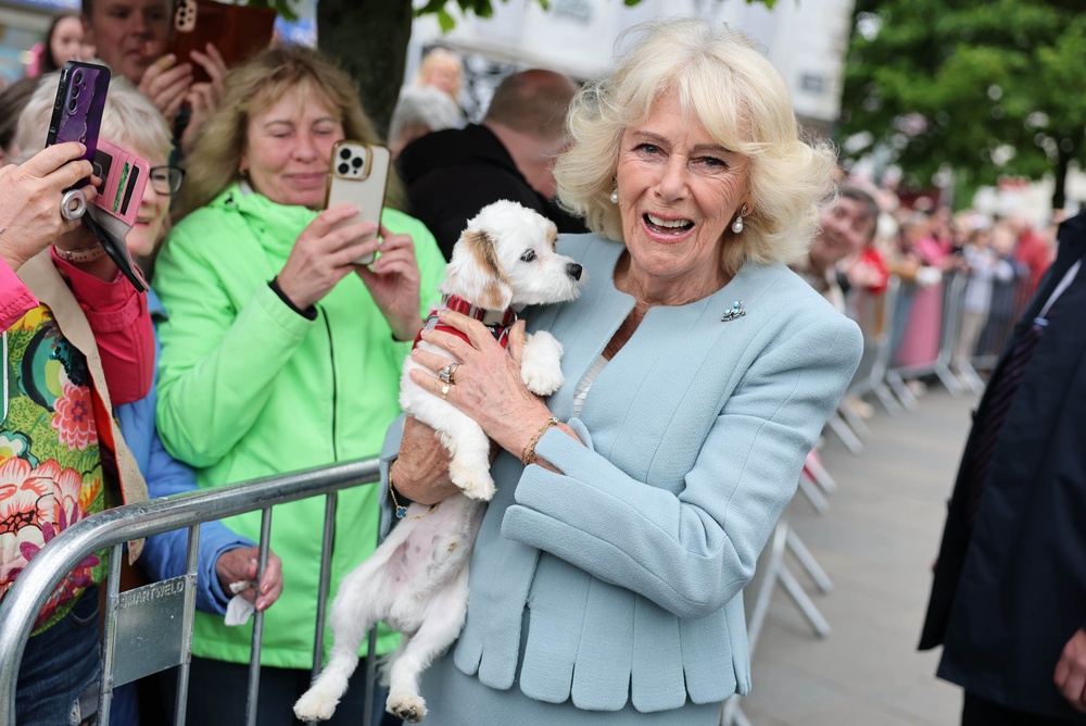 Camilla cuddled one well-wisher’s four-legged friend in Conway Square, Newtownards (Chris Jackson/PA) (PA Wire)