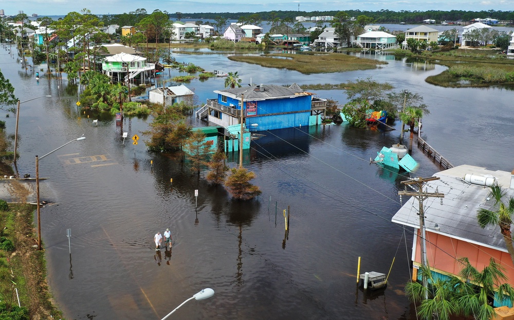 An aerial view from a drone shows people walking through a flooded street after Hurricane Sally hit Gulf Shores, Alabama, in September 2020. Last year was eerily quiet for Atlantic hurricanes making landfall in the U.S. (Getty)