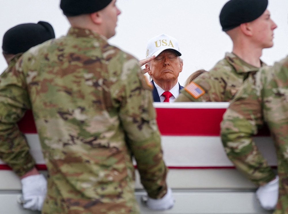Donald Trump salutes as members of the military carry a transfer case during a dignified transfer of the remains of six U.S. Army service members killed in Kuwait, deaths that survivors say could have been prevented with adequate medical resources (REUTERS)