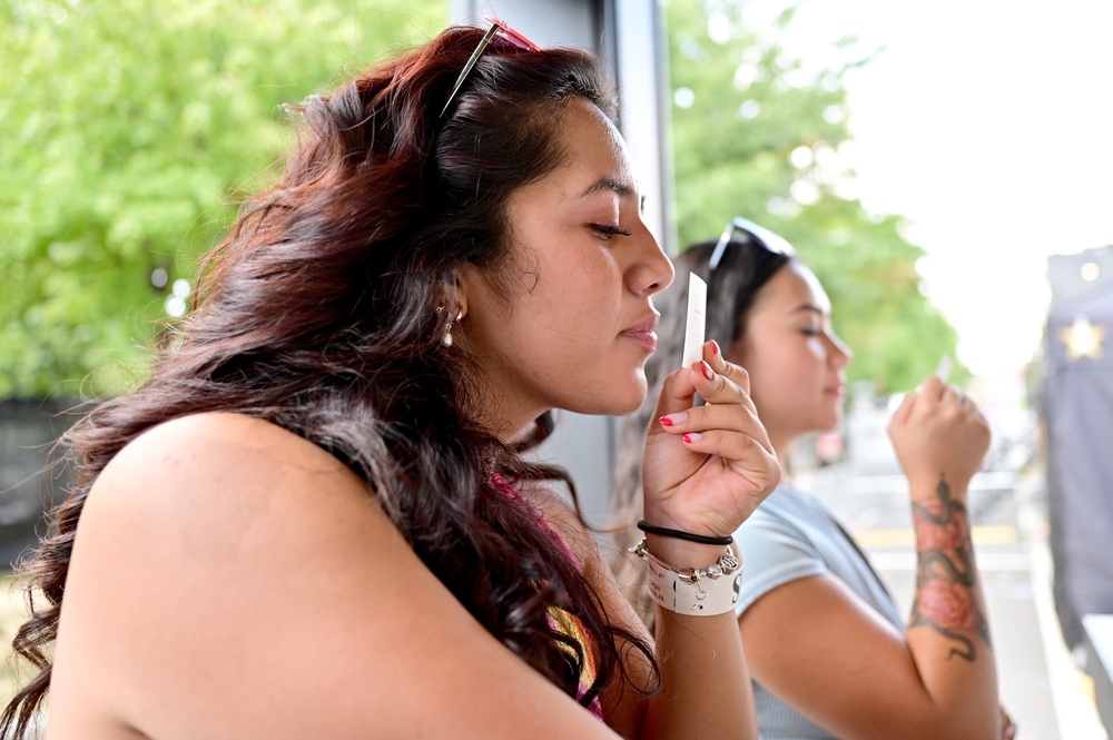 Festival-goers sample perfume at an event in Philadelphia in September 2022. Gen Z has helped drive perfume sales in recent years (Getty)