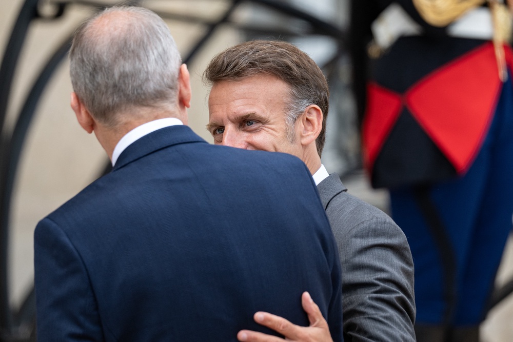 Micheal Martin (L), Prime Minister of Ireland, seen from behind, is welcomed by Emmanuel Macron (R), (AFP/Getty)