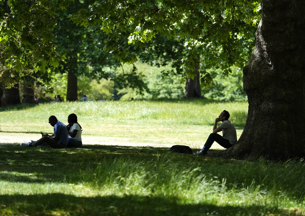 People enjoying the warm weather in St James’s Park in London (Jordan Pettitt/PA) (PA Wire)