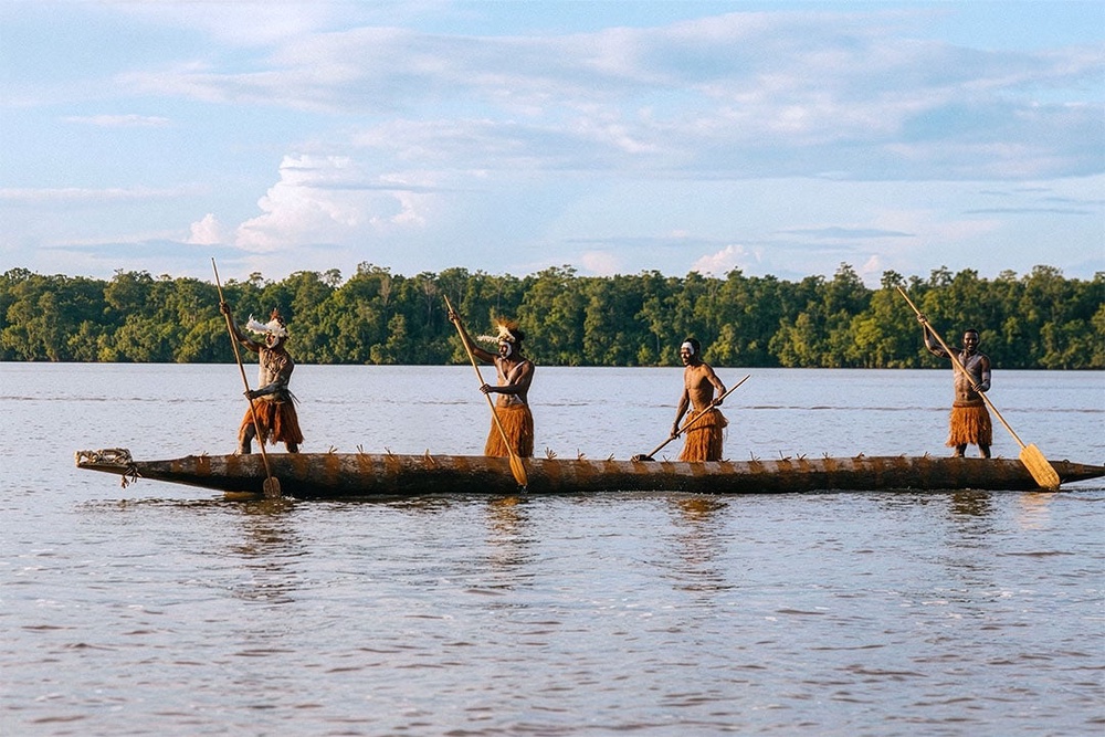 Members of the Asmat tribe on a canoe (Aqua Expeditions)